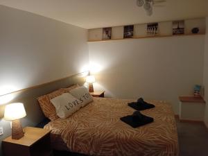 a bedroom with a bed with two hats on it at Gite Happy Sun Flower in Virlet +42 photos