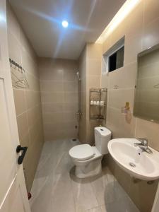 a bathroom with a toilet and a sink at Hana Farm in Hanoi +11 photos