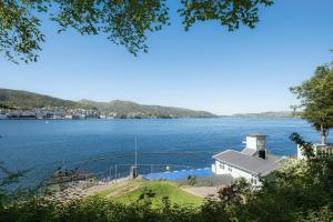 Blick auf ein großes Gewässer mit einem Leuchtturm in der Unterkunft Nordnes Apartment in Bergen
