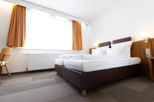 Postel nebo postele na pokoji v ubytování Hotel Darstein