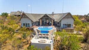 an aerial view of a house with a swimming pool at Tebuah Private Lodge, Mabalingwe in Mabula