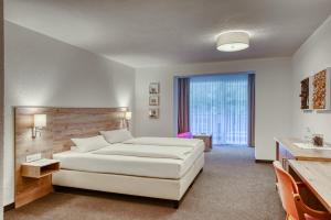 Postel nebo postele na pokoji v ubytování Hotel Erika