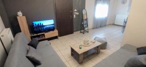 a living room with a couch and a tv at La casa bella di Chalkida in Chalkida +9 photos