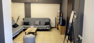 a living room with a couch and a tv at La casa bella di Chalkida in Chalkida