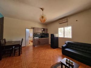 a living room with a couch and a table at Villa Saidia Blue avec PISCINE in Diego Suarez