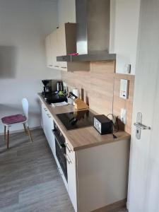 a kitchen with a counter and a stove top oven at Ferienwohnung Ostseeblick am Breitling Whg 5 in Malchow +28 photos
