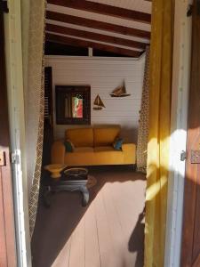 a living room with a couch and a table at Habitation Madame Rosalie in Vieux-Habitants