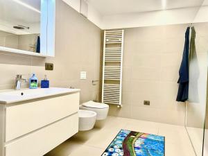 a bathroom with a sink and a toilet at Casa delle rondini in Rovereto