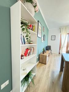 a room with white shelves with books at La Casa di Enea in Rome
