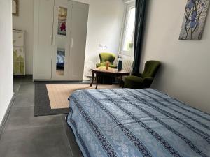 a bedroom with a bed and a table and chairs at Guesthouse Ostello dell Arte in Trarego Viggiona