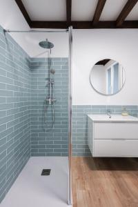 a bathroom with blue subway tiles and a shower at Apartamentos Bágoas de Mencía Peares Ribeira Sacra in Carballedo