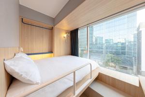 Postel nebo postele na pokoji v ubytování Uhoostay Myeongdong Guesthouse + 36 fotografií