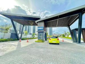 a yellow car parked in front of a gas station at Iloilo Condo Sm City Style Residences in Iloilo City