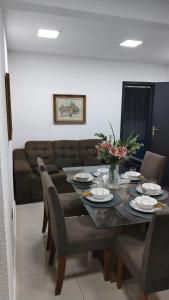 a dining room with a table and a couch at Stefanich Aparthotel in Ciudad del Este