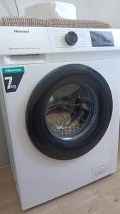 a white washing machine with a wheel on top of it at cristina in Pavia