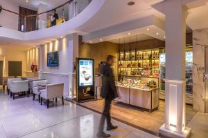 a person walking through a restaurant with a vending machine at Up Tribeca in Buenos Aires
