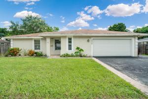 a white house with a garage at 4BR Naples Getaway Pool, Gazebo & Near Beach in Naples