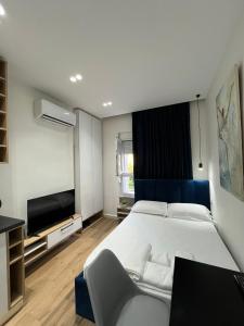 a bedroom with a large bed and a flat screen tv at Apartament in Blloku in front of Taiwan in Tirana