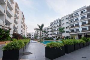 an apartment complex with a courtyard with a swimming pool at Luxury Suite Mannesmann - Seaview in Mohammedia