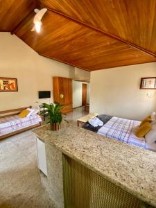 a hotel room with two beds and a counter at Pousada Lua Cheia in Búzios