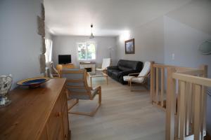 a living room with a couch and a table at Maison avec piscine 10 couchages in Pornichet