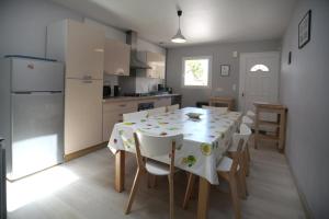 a kitchen and dining room with a table and chairs at Maison avec piscine 10 couchages in Pornichet