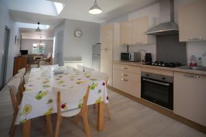a kitchen and dining room with a table and chairs at Maison avec piscine 10 couchages in Pornichet +16 photos