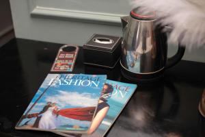 a book and a magazine on a table at Madelise Stardust Hotel & Travel in Hanoi +22 photos