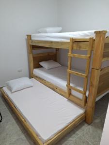two bunk beds in a room with a ladder at Apartahotel- Alojamiento Familiar- Apartamentos Privados Kira in Buenavista