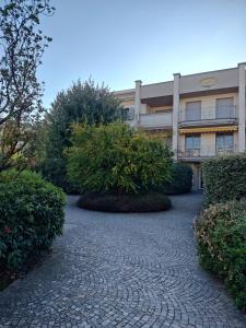 a building with a brick path in front of a building at Sunset Penthouse in Gessate