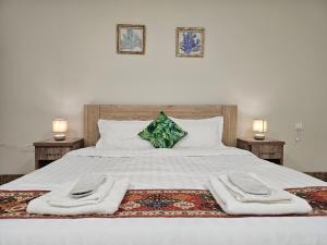 a bedroom with a bed with two towels on it at مورايا Murraya in Abyār ‘Alī +83 photos