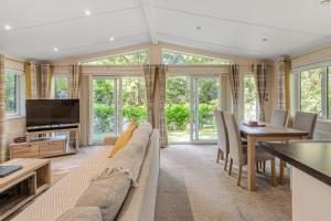 a living room with a couch and a table at Chycara House in Truro +23 photos