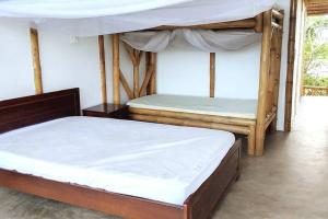 Postel nebo postele na pokoji v ubytování Casa de Guadua