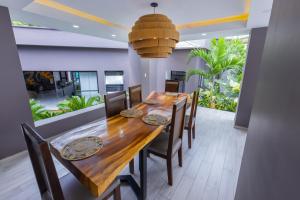 a dining room with a wooden table and chairs at Milenio in Cali