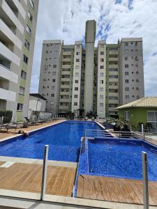 a swimming pool in front of a large building at Apto.napraia BEACH 901 em Piçarras com vista mar in Piçarras