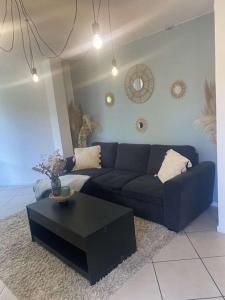 Una sala de estar con un sofá azul y una mesa de café. en T2 Compiegne, en Compiègne