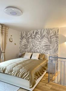 a bedroom with a large bed with a leaf wallpaper at Le petit bain du Logis in Précy-sous-Thil +29 photos