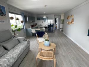 a living room with a couch and a table at Charming Condo in Sri Racha in Si Racha