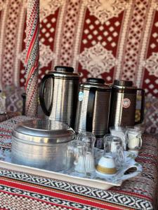 a group of coffee pots and glasses on a table at SAFARI-Glamping in Badīyah +48 photos