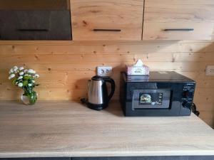 a coffee maker sitting on a counter with a coffee pot at Na Hutori in Tatariv