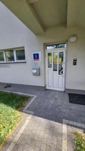 a door to a building with a gas station at Pokoje przy szpitalu - Lwowska in Rzeszów +13 photos