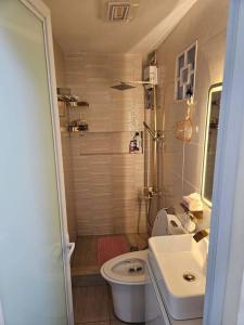 a small bathroom with a toilet and a sink at Family Friendly House in Malolos +17 photos