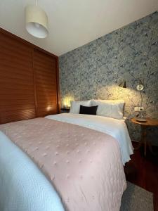 a bedroom with a large white bed in a room at Apartamento Galeguiña in Vigo +15 photos