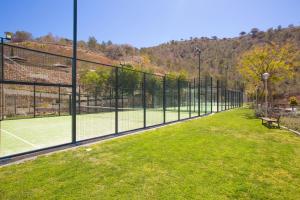 a tennis court with a net on the grass at Skyscraper apartment with panoramic views - floor 38 in Benidorm