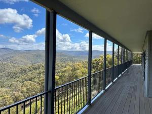 a balcony of a house with a view of the mountains at Golden Valley - Steels Creek in Steels Creek