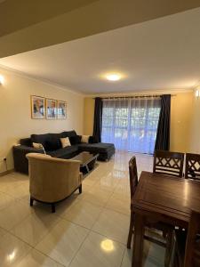 a living room with a couch and a table at Munyonyo Apartment in Kampala