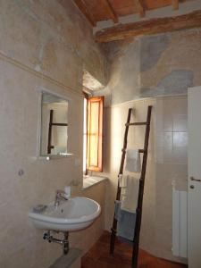 a bathroom with a sink and a mirror at Logge medicee appartamento grande in Barberino di Mugello