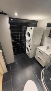 a bathroom with a toilet and a washing machine at Vassfjellet Home in Trondheim +20 photos