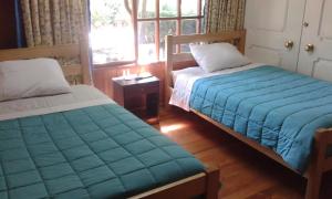 Postel nebo postele na pokoji v ubytování Hostal Kutralwe