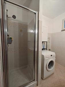 a bathroom with a washing machine and a washer at Sunset Penthouse in Gessate +29 photos